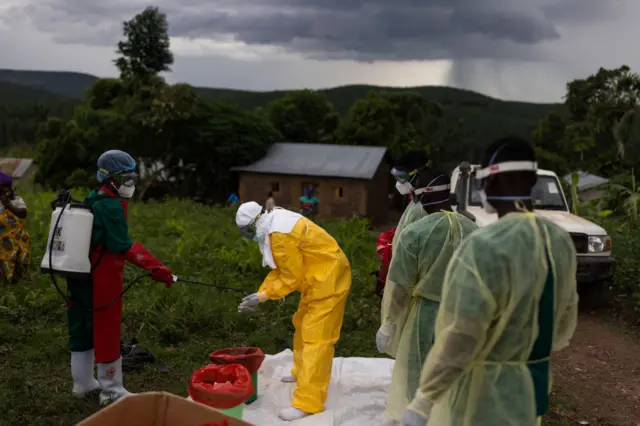 Ugandan Red Cross workers put on PPE prior to a Safe and Dignified Burial on October 11, 2022 in Mubende, Uganda.