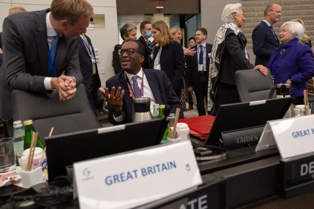 Kwasi Kwarteng pictured at IMF meetings in Washington before dashing home