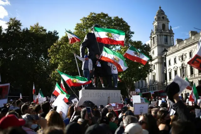 People demonstrate outside the Houses of Parliament in London on 8 October