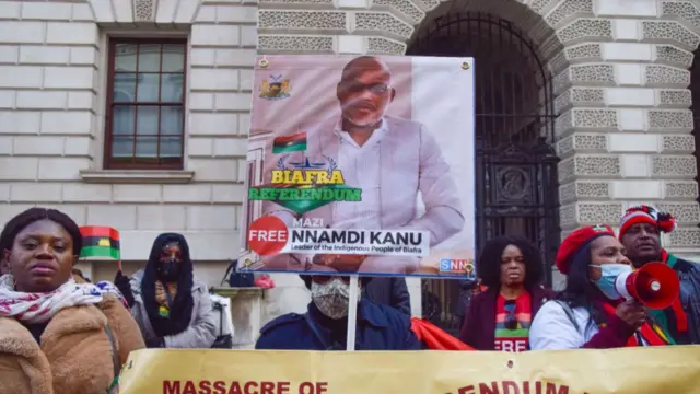 A demonstrator holds a picture of Nnamdi Kanu during a protest in London