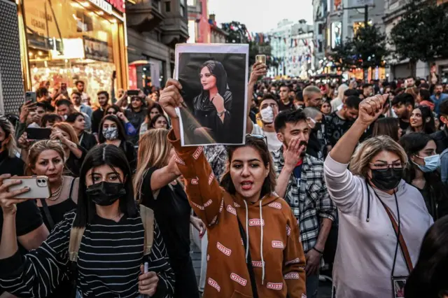 A protester holds a portrait of Mahsa Amini in Istanbul, Turkey, on 20 September