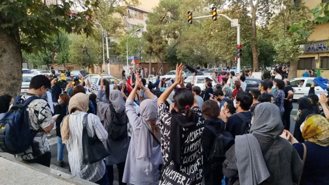 People gather to protest in Tehran on 19 September