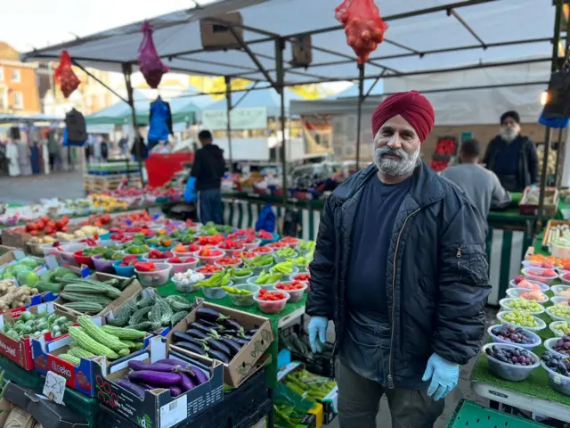 Santokh at his fruit and veg stall in Romford