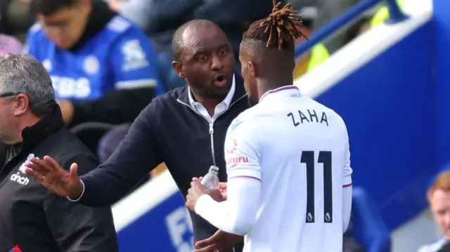 Patrick Vieira speaking to Wilfried Zaha during the game.