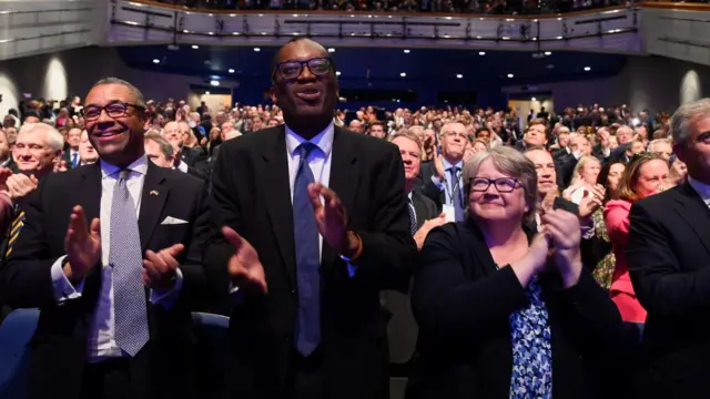 Foreign Secretary James Cleverly, former chancellor Kwasi Kwarteng and Deputy PM Therese Coffey applaud Liz Truss during the Tory conference earlier this month