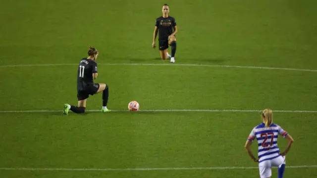 Players, including  Vivianne Miedema, taking the knee before the match.