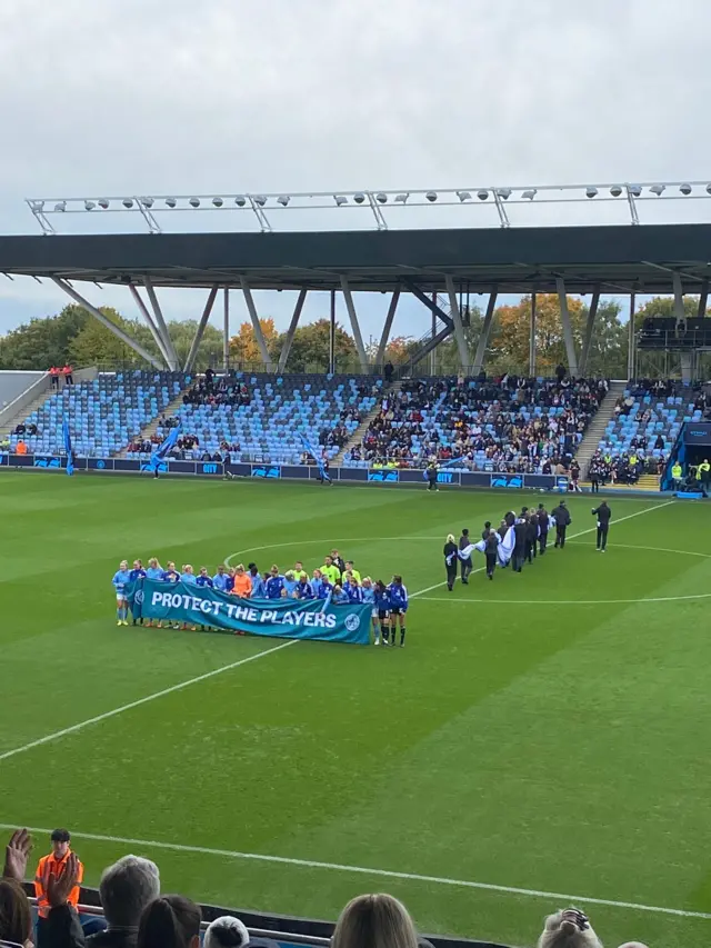 City and Leicester players hold up 'Protect the Players' banner