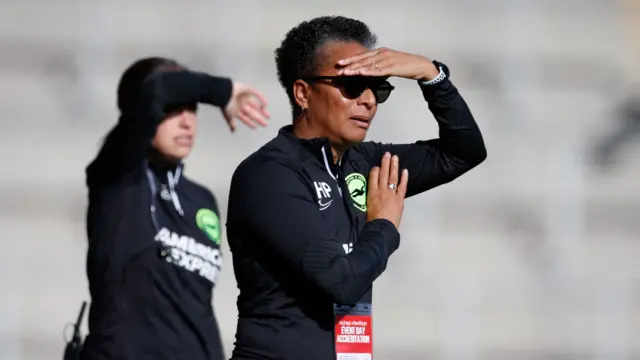 Hope Powell watches on.