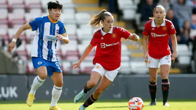 Ella Toone of Manchester United and Lee Geum-min of Brighton in action