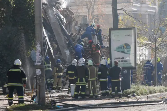 Rescuers struggle through rubble to find survivors.