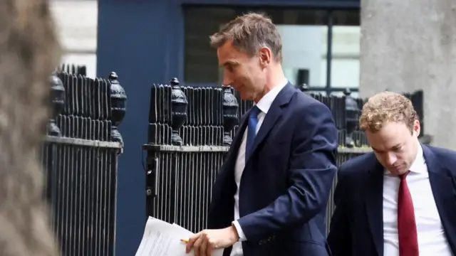 British Chancellor of the Exchequer Jeremy Hunt walks outside Downing Street in London, Britain, 17 October 2022