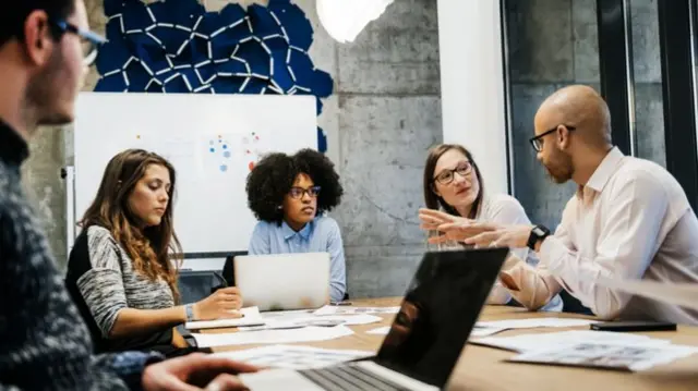 A group holding a business meeting in an office