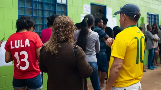 People queue to vote at a school during presidential election day on October 2, 2022 in Ceilândia, about 40 km from Brasilia, Brazil