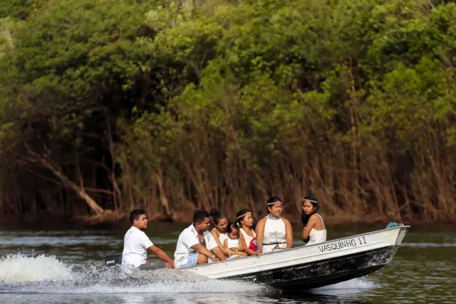 Indigenous Kambeba people ride on boat to neighbouring São Sebastião community to vote in the state of Amazonas