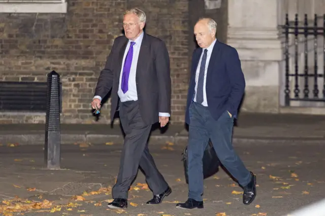 Sir Christopher Chope walking with a man outside Downing Street