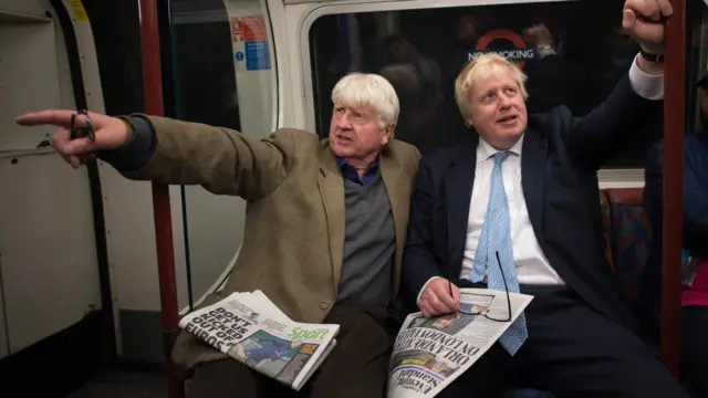 Boris Johnson and his father Stanley with newspapers on the London Underground