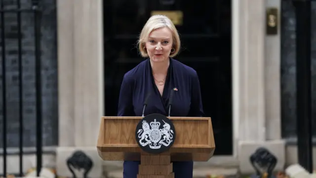 Liz Truss standing at a podium outside Downing Street