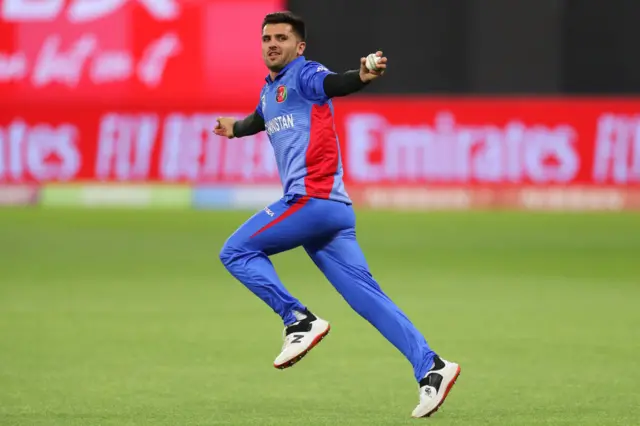 Fazalhaq Farooqi of Afghanistan celebrates catching out Alex Hales