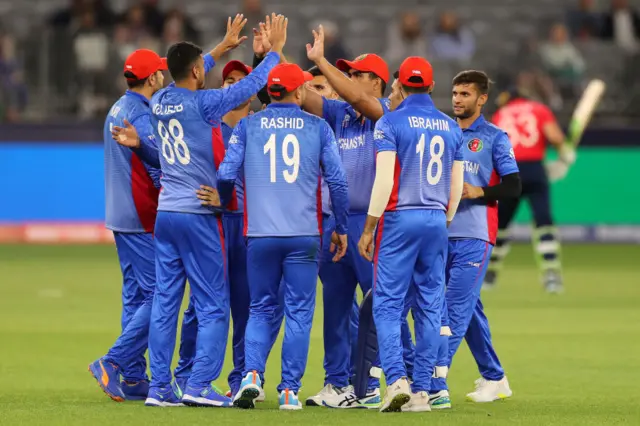 Mujeeb ur Rahman of Afghanistan celebrates with team mates after catching out Jos Buttler