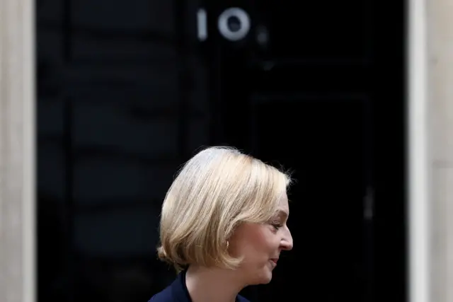 Liz Truss in profile outside the door of No 10