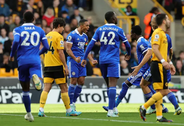 Youri Tielemans celebrates with teammates after scoring their team's first goal