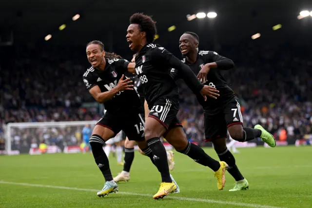 Willian celebrating with teammates Bobby Reid and Neeskens Kebano as Fulham extend their lead