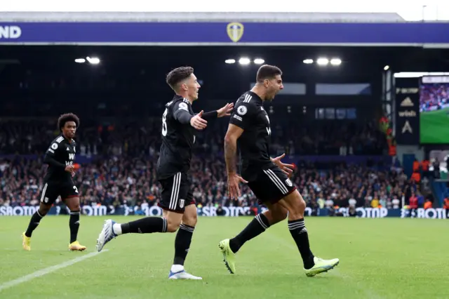 Aleksandar Mitrovic celebrates with teammate Harry Wilson after equalising with Leeds