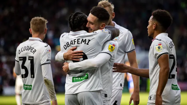 Matt Grimes celebrates with Michael Obafemi