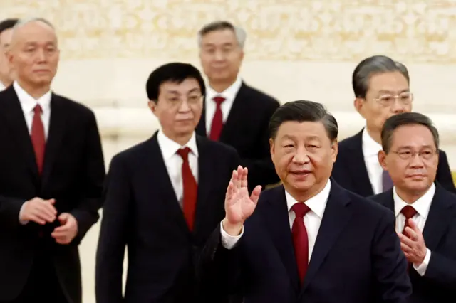 Xi Jinping waves at the crrowd as he stands in front of his new Standing Committee