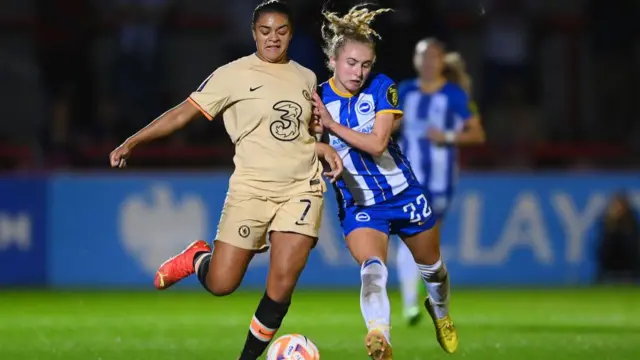 Katie Robinson battles for the ball with Jess Carter.