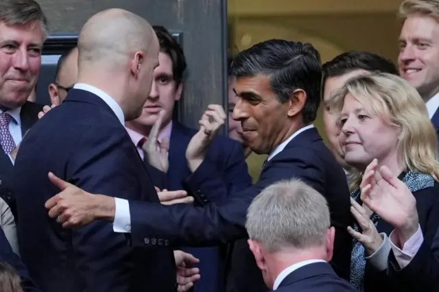 Rishi Sunak giving someone a thumbs up outside Tory HQ