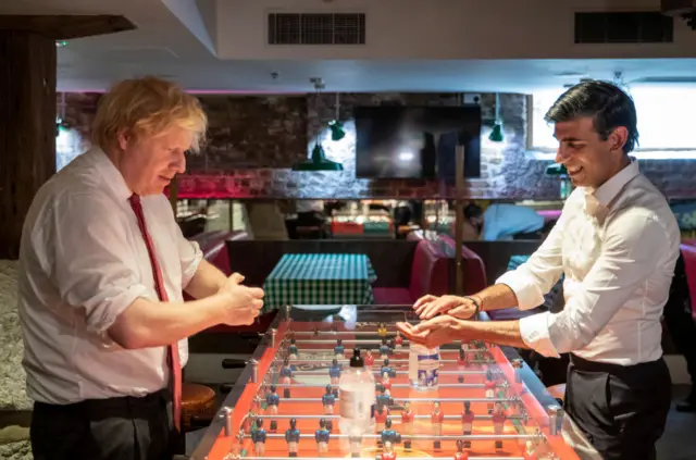 Former Prime Minister Boris Johnson and then-Chancellor Rishi Sunak play table football at a London restaurant