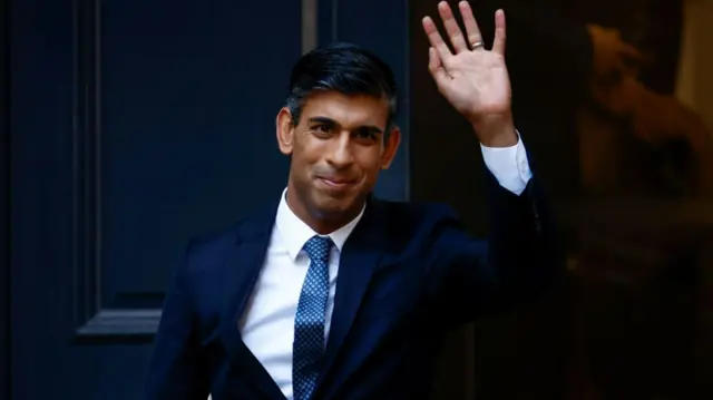 Rishi Sunak waves outside Conservative Party Headquarters