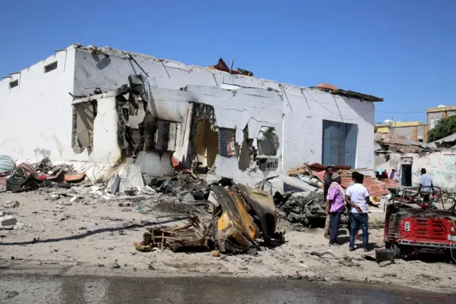 A view of damage at the scene after a suicide car blast targeted a security convoy in Mogadishu, Somalia on January 12, 2022.