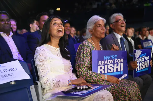 Rishi Sunak's wife Akshata Murthy (L) with his parents Usha Sunak (C) and Yashvir Sunak (R) at the Conservative Party leadership election hustings at Wembley Arena, London, on 31 August 2022.