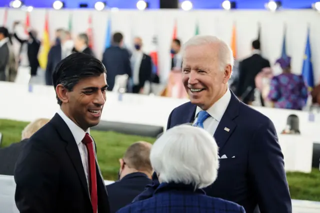 US President Joe Biden speaks to the UK's then-chancellor, Rishi Sunak, in 2021