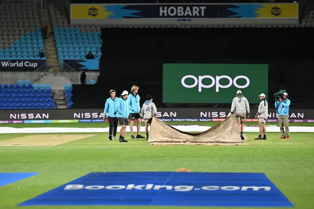 The grounstaff taking the covers off