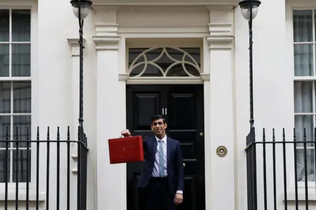 Rishi Sunak stands outside No 11 Downing Street with the Budget red box