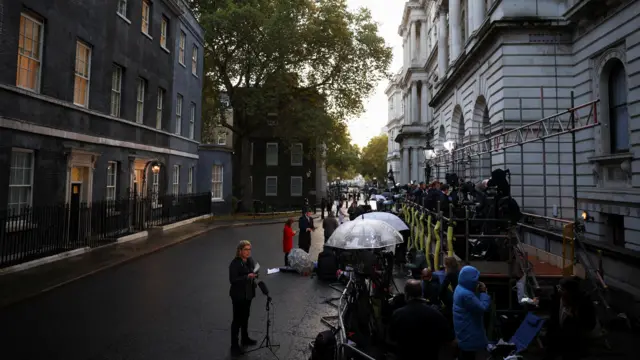 Members of the media stand outside 10 Downing Street this morning