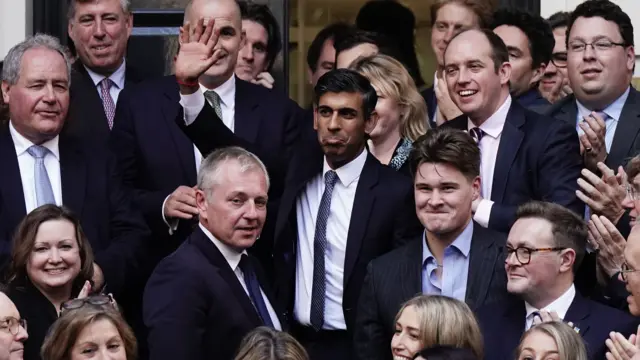 Rishi Sunak poses outside Conservative party HQ in Westminster yesterday