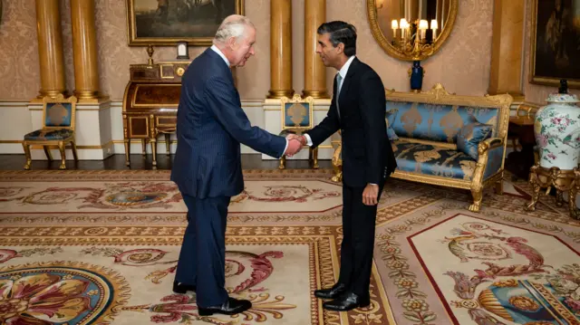 King Charles III welcomes Rishi Sunak during an audience at Buckingham Palace