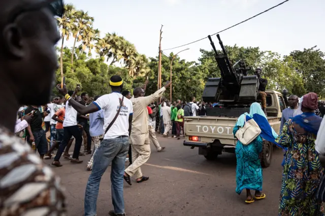 People cheer at the army during the ceremony for the 35th anniversary of Thomas Sankaras assassination, in Ouagadougou, on October 15, 2022