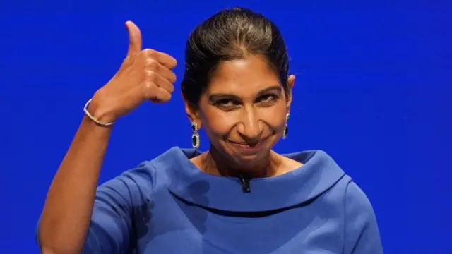 Suella Braverman gives a thumbs-up sign