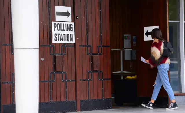 Woman walking into polling station