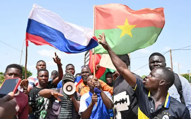 Russia and Burkina Faso flags are waved by small group of protesters