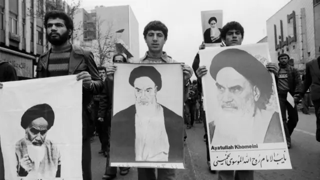 Protesters carry banners with pictures of Ruhollah Khomeini in Tehran in 1978