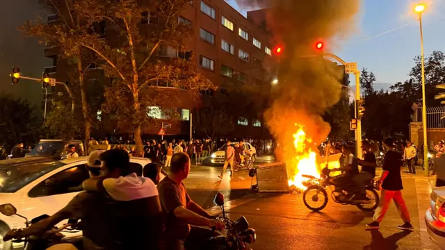 A police motorcycle burns during a protest over the death of Mahsa Amini in Tehran last month