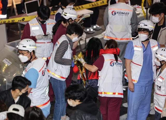 Medical workers attend to victims following the deadly stampede