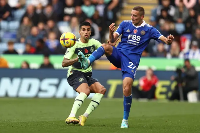 Joao Cancelo and Timothy Castagne battling to win the ball