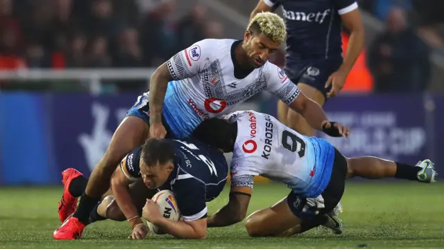 Scotland player tackled by Fiji